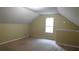 Cozy attic space with carpet, dormer window, and painted walls at 330 Christian Woods Dr, Conyers, GA 30013
