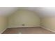 Spacious finished attic with carpet flooring, neutral walls, and a small door on the left at 330 Christian Woods Dr, Conyers, GA 30013