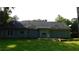 Exterior back view of a single-story home with a covered patio and a lush green backyard at 330 Christian Woods Dr, Conyers, GA 30013