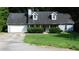 Charming single-story home with blue siding, dormer windows, a 2-car garage, and a well-maintained front yard at 330 Christian Woods Dr, Conyers, GA 30013