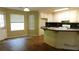 An open-concept kitchen featuring white cabinets and a view of the yard at 330 Christian Woods Dr, Conyers, GA 30013