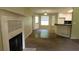 Open-concept living room and kitchen layout featuring a fireplace at 330 Christian Woods Dr, Conyers, GA 30013