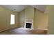 A living room featuring a fireplace, large window, and vaulted ceiling at 330 Christian Woods Dr, Conyers, GA 30013