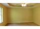 A main bedroom with a ceiling fan and large window at 330 Christian Woods Dr, Conyers, GA 30013