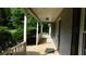 Inviting covered porch with classic railing and partial views of landscaped front yard at 330 Christian Woods Dr, Conyers, GA 30013