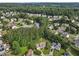 Aerial view showcasing a neighborhood with lush greenery, mature trees, and well-maintained homes at 405 Mount Vernon Ct, Woodstock, GA 30189