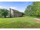 Expansive backyard view showcases the home's outdoor space and mature trees, perfect for Gathering activities and entertaining at 405 Mount Vernon Ct, Woodstock, GA 30189