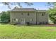 The backyard features a well-maintained lawn and mature trees, providing a serene outdoor space at 405 Mount Vernon Ct, Woodstock, GA 30189