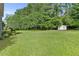 The backyard features a lush, green lawn and a storage shed, perfect for outdoor activities at 405 Mount Vernon Ct, Woodstock, GA 30189