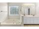 A large soaking tub is the focal point of this bathroom with double sinks at 405 Mount Vernon Ct, Woodstock, GA 30189