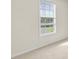 A bedroom window offers natural light and a glimpse of the landscape at 405 Mount Vernon Ct, Woodstock, GA 30189