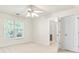 Bright bedroom with a ceiling fan and a window that lets in plenty of natural light and also features 2 doors at 405 Mount Vernon Ct, Woodstock, GA 30189