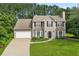 Charming two-story home features a manicured lawn, attached garage, and classic architectural details at 405 Mount Vernon Ct, Woodstock, GA 30189