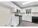 Kitchen with stainless steel range and microwave and white cabinets at 405 Mount Vernon Ct, Woodstock, GA 30189