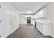 Kitchen with door to the exterior and view into an open living area at 405 Mount Vernon Ct, Woodstock, GA 30189
