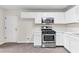 Kitchen with stainless steel oven/range, white cabinets and door to another room at 405 Mount Vernon Ct, Woodstock, GA 30189