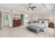 This well lit main bedroom features a tray ceiling, ceiling fan, and sitting area at 405 Mount Vernon Ct, Woodstock, GA 30189