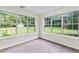 Bright sunroom with large windows offer an abundance of natural light and garden view at 405 Mount Vernon Ct, Woodstock, GA 30189