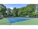 Well-maintained tennis courts surrounded by lush greenery, providing a great recreational amenity at 405 Mount Vernon Ct, Woodstock, GA 30189