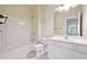 Bright bathroom featuring a tub with shower, white vanity with sink, and ceramic tile flooring at 6043 China Rose Lane, Johns Creek, GA 30097