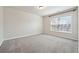 Spacious bedroom with carpeted flooring, a window and neutral walls at 6043 China Rose Lane, Johns Creek, GA 30097