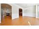 Open-concept dining area with hardwood floors and wainscoting, adjacent to the kitchen at 6043 China Rose Lane, Johns Creek, GA 30097