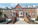 Brick townhome with attached garages, symmetrical window placement, and well-maintained landscaping at 6043 China Rose Lane, Johns Creek, GA 30097