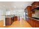 Modern kitchen features dark wood cabinets, granite countertops, stainless steel appliances, and tile backsplash at 6043 China Rose Lane, Johns Creek, GA 30097