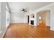 Spacious living room featuring hardwood floors, a fireplace, and arched doorways at 6043 China Rose Lane, Johns Creek, GA 30097