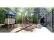Community playground with a slide, swings, and other play equipment for children to enjoy at 6043 China Rose Lane, Johns Creek, GA 30097