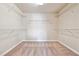 Large walk-in closet with carpet flooring and plenty of shelving for storage at 6043 China Rose Lane, Johns Creek, GA 30097