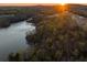 Scenic aerial view of wooded community and lake at sunrise at 1063 Winding Branch Dr, Canton, GA 30114