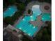 An illuminated aerial view of the sparkling pools and splash pad surrounded by lush landscaping at 1063 Winding Branch Dr, Canton, GA 30114