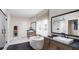 Spa-like bathroom with a soaking tub, dual vanities, a walk-in shower, and elegant finishes at 1063 Winding Branch Dr, Canton, GA 30114