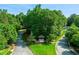 Community entrance with stone signage surrounded by lush trees at 1063 Winding Branch Dr, Canton, GA 30114