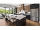 Modern kitchen featuring an island with seating, stainless steel appliances, and backyard views at 1063 Winding Branch Dr, Canton, GA 30114