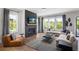 Bright living room with a fireplace, hardwood floors, neutral decor, and multiple windows for natural light at 1063 Winding Branch Dr, Canton, GA 30114