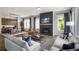 Open-concept living room with a fireplace, hardwood floors, comfortable seating, and a view into the dining area at 1063 Winding Branch Dr, Canton, GA 30114