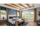 Serene main bedroom with natural light, hardwood floors, a king-sized bed, and exposed ceiling beams at 1063 Winding Branch Dr, Canton, GA 30114