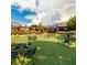 Outdoor gathering space with green turf, patio seating, and mature trees at 1063 Winding Branch Dr, Canton, GA 30114