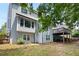 Exterior view of the back of the house, showcasing the deck, lush greenery, and ample windows at 113 Stargaze Rdg, Canton, GA 30114