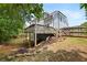 Spacious backyard featuring a multilevel wooden deck, lawn area and mature trees at 113 Stargaze Rdg, Canton, GA 30114