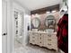 Unique bathroom featuring a vanity with vessel sinks, a wood accent wall, and a view of the shower at 113 Stargaze Rdg, Canton, GA 30114