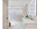 Bright bathroom featuring dual sinks with white marble countertops, white cabinetry, and walk-in shower at 113 Stargaze Rdg, Canton, GA 30114