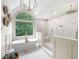Bright bathroom with a large window, soaking tub, and tiled walk-in shower with dual shower heads at 113 Stargaze Rdg, Canton, GA 30114