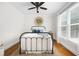 Cozy bedroom with a black metal bed frame, hardwood floors, and natural light from the window at 113 Stargaze Rdg, Canton, GA 30114