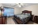 Comfortable bedroom featuring a ceiling fan, wood-look flooring, large window and queen-sized bed at 113 Stargaze Rdg, Canton, GA 30114
