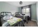 Cozy bedroom with two twin beds, window, and black metal frames at 113 Stargaze Rdg, Canton, GA 30114