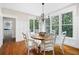 Sunlit dining room with a round table, white chairs, and large windows overlooking the outdoors at 113 Stargaze Rdg, Canton, GA 30114