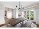 Bright dining room with a chandelier, a table with bench seating, and views of the yard at 113 Stargaze Rdg, Canton, GA 30114